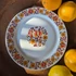 Alföldi Porcelán tányér népi virágmintával, őszi színekben, középen és peremén díszítéssel