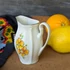 Sárga virágos porcelán tejkiöntő